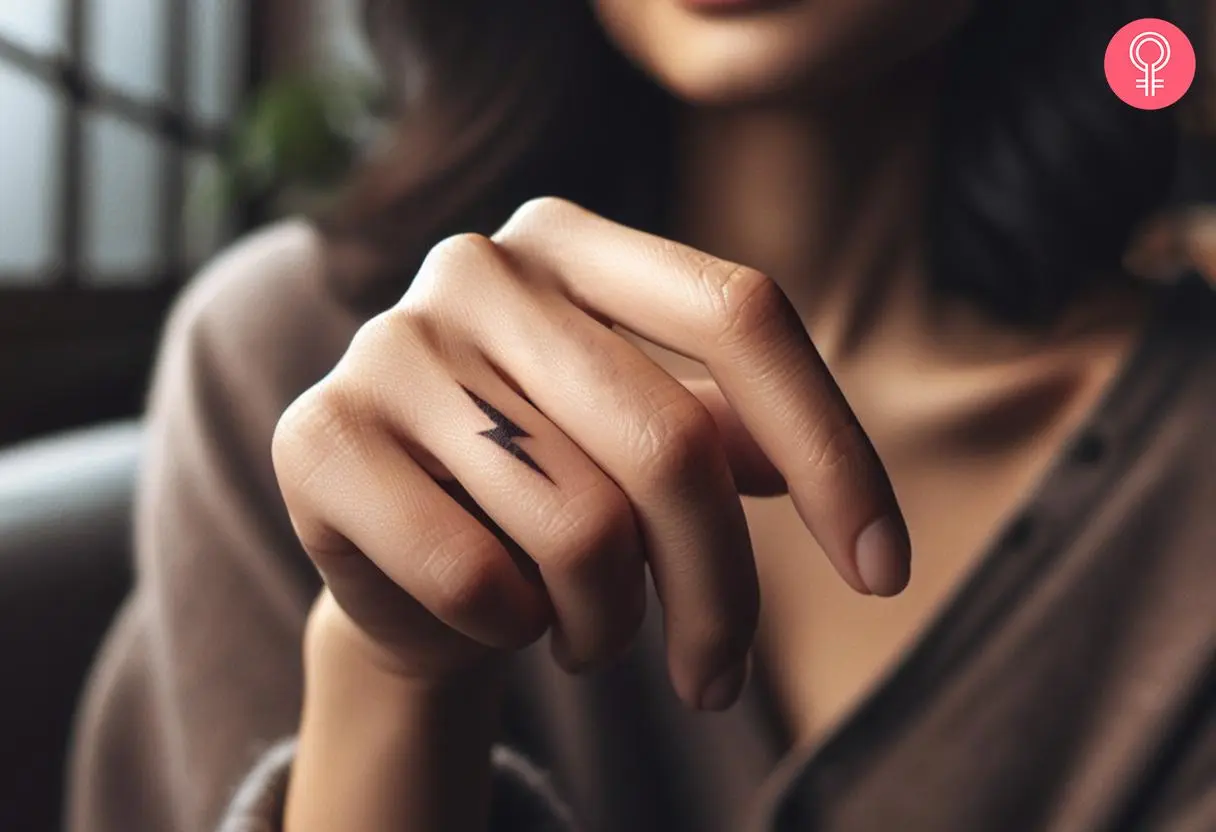 A woman with a black lightning bolt tattoo on her finger