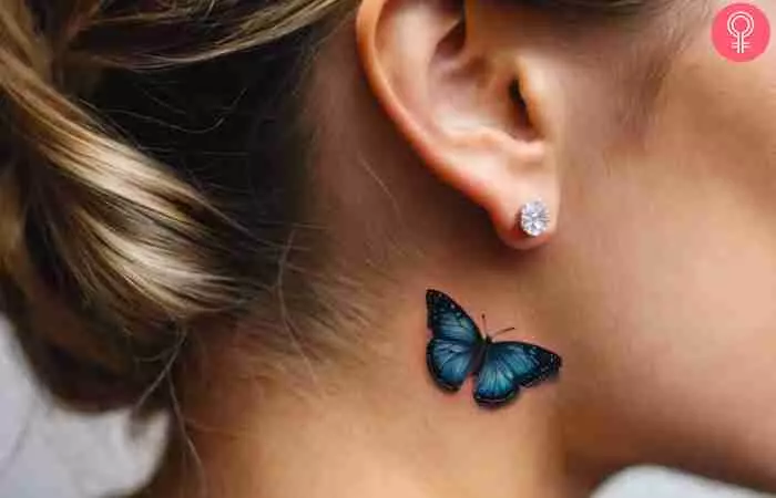 A woman with a blue butterfly tattoo on the side of her neck