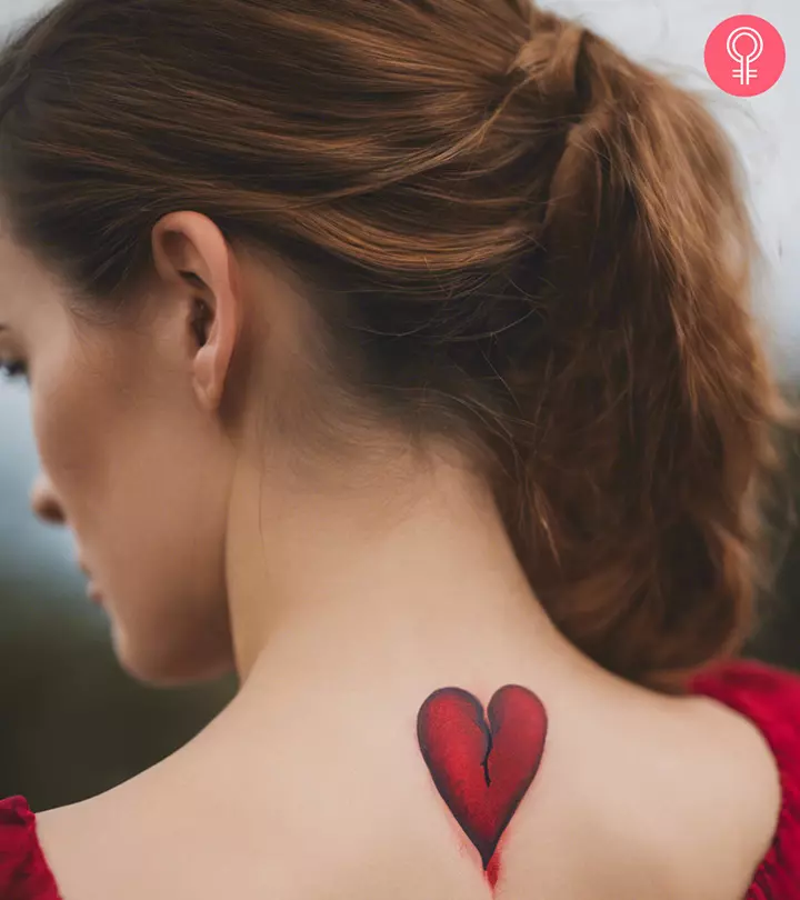 A woman with a broken heart tattoo on her upper back