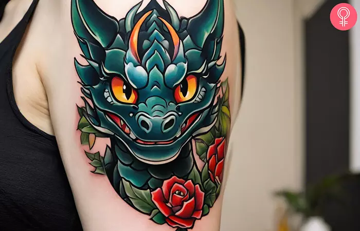 A woman with a cartoon dragon tattoo on her upper arm