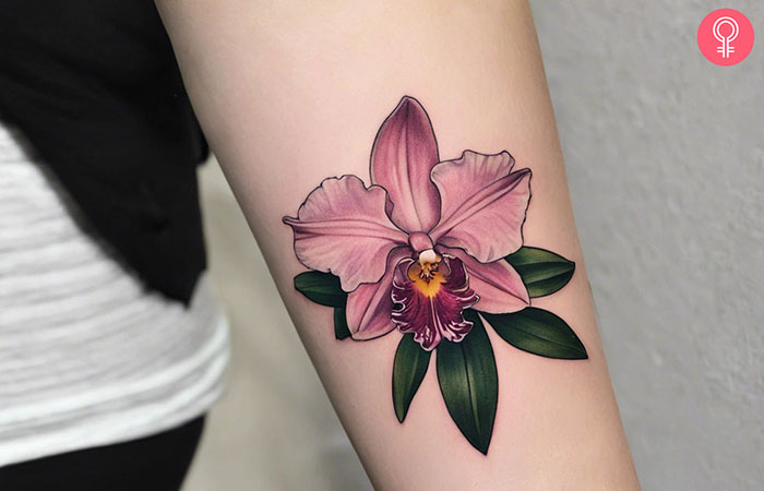 A woman with a cattleya orchid tattoo on her arm