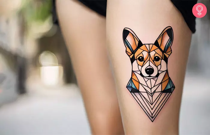 A woman with a colorful, geometric corgi tattoo on her thigh