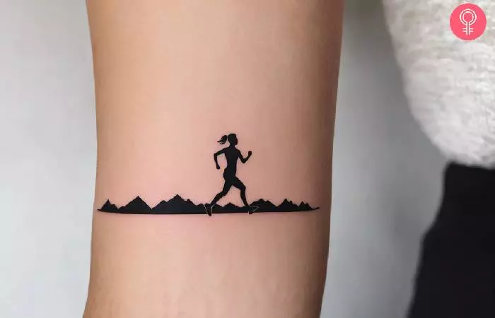 A woman with a cool running tattoo on the forearm