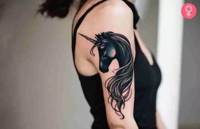 A woman with a dark unicorn tattoo on her arm