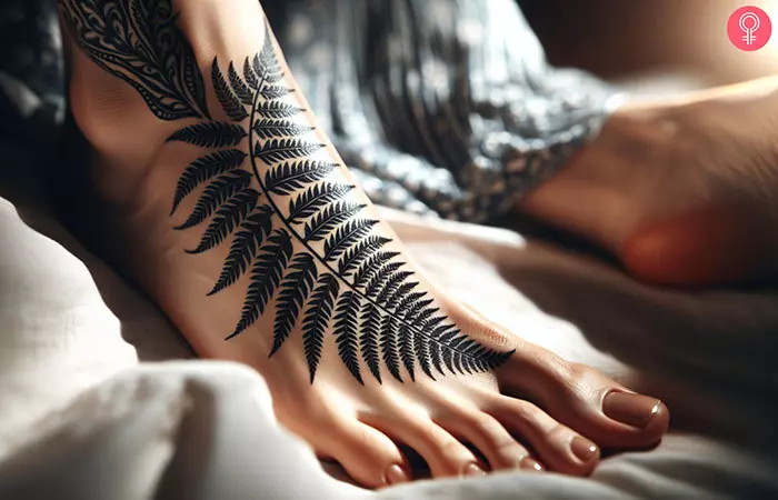 A woman with a fern leaf tattoo on her foot