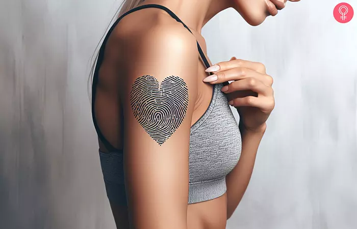 A woman with a fingerprint heart tattoo on her upper arm