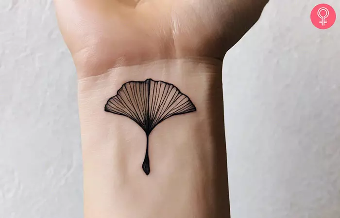 A woman with a ginkgo leaf tattoo on her wrist