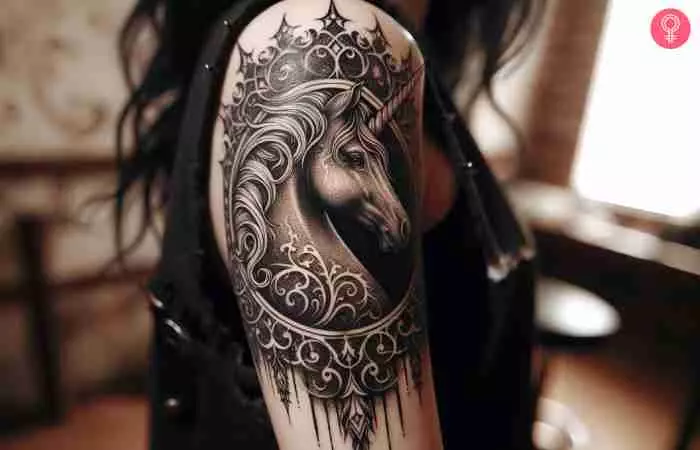 A woman with a gothic unicorn tattoo on her upper arm