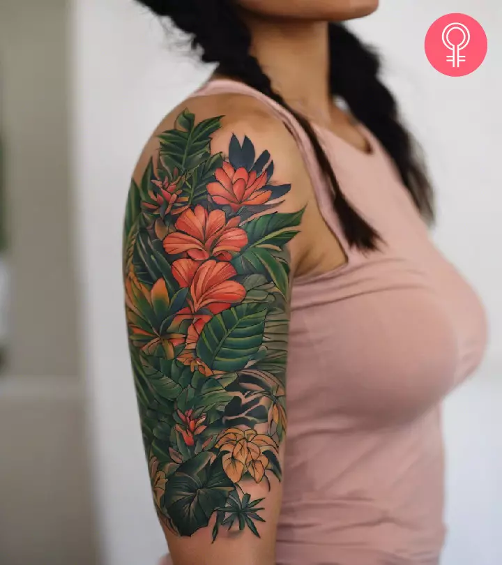 A woman with a jungle sleeve tattoo on her upper arm