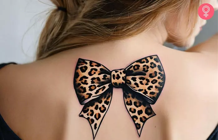 A woman with a leopard print tattoo on her upper back