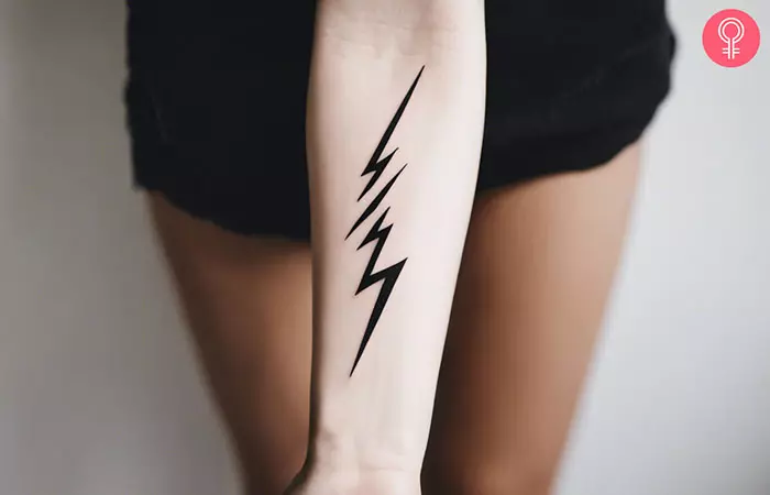 A woman with a lightning bolt tattoo on her forearm