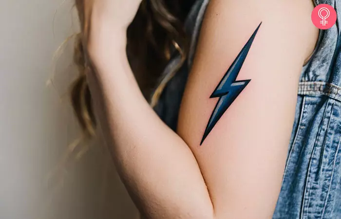 A woman with a lightning bolt tattoo on her upper arm
