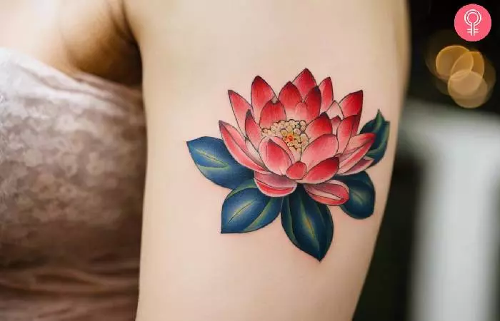 A woman with a lotus Tebori tattoo design on her upper arm