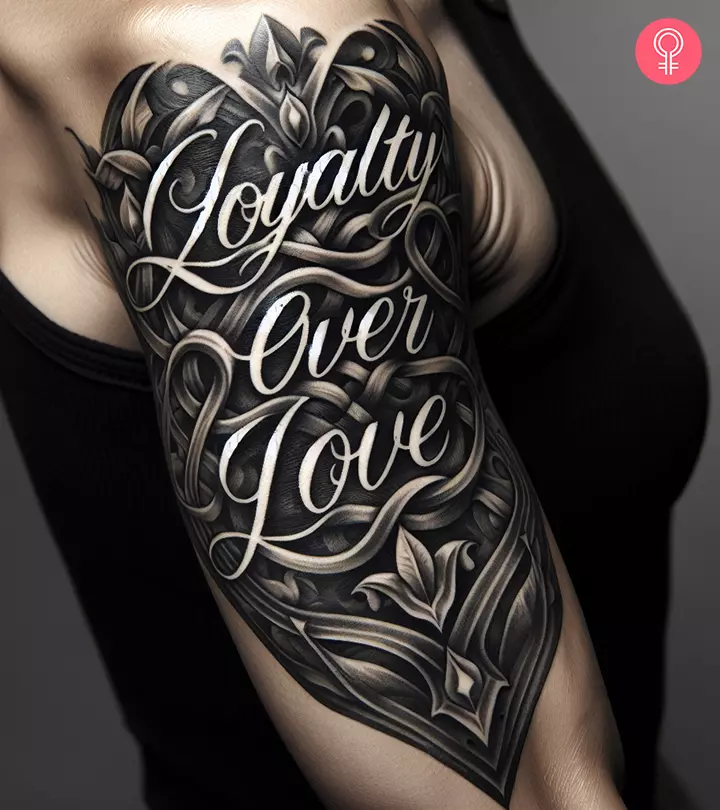 A woman with a loyalty over love tattoo on her upper arm