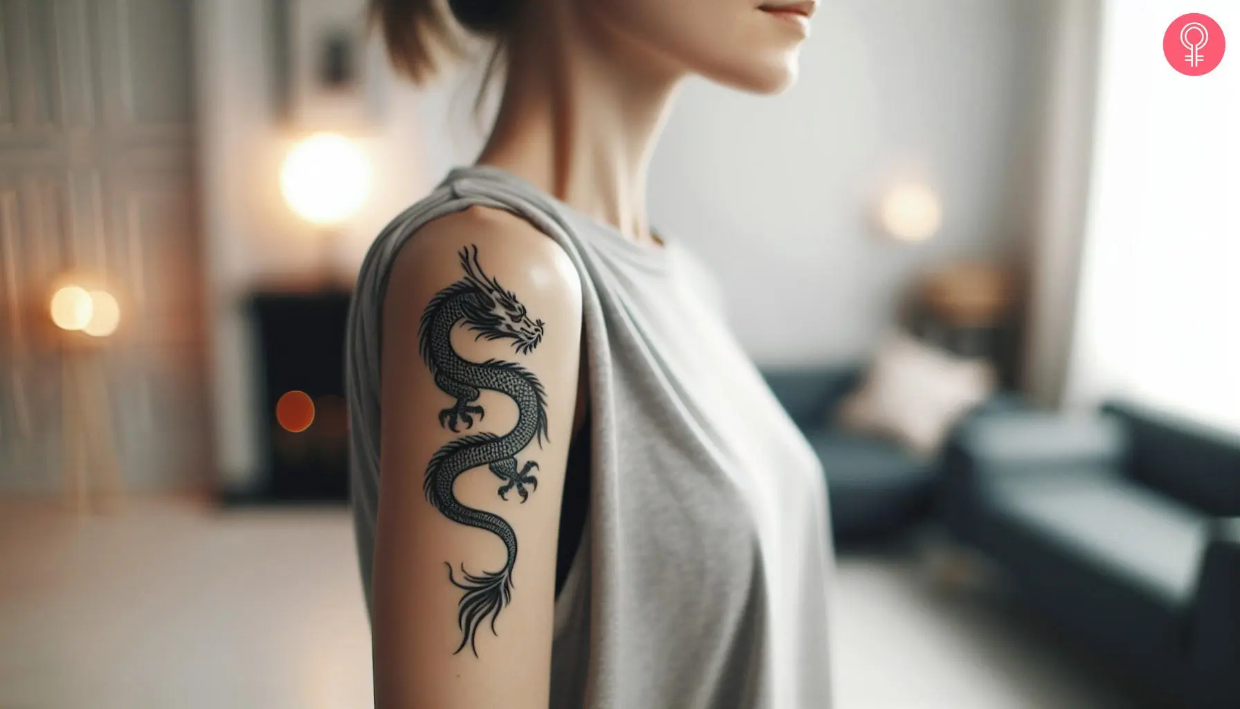 A woman with a minimalist Japanese dragon tattoo on her upper arm