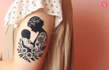 A woman with a mom and baby tattoo on her upper arm