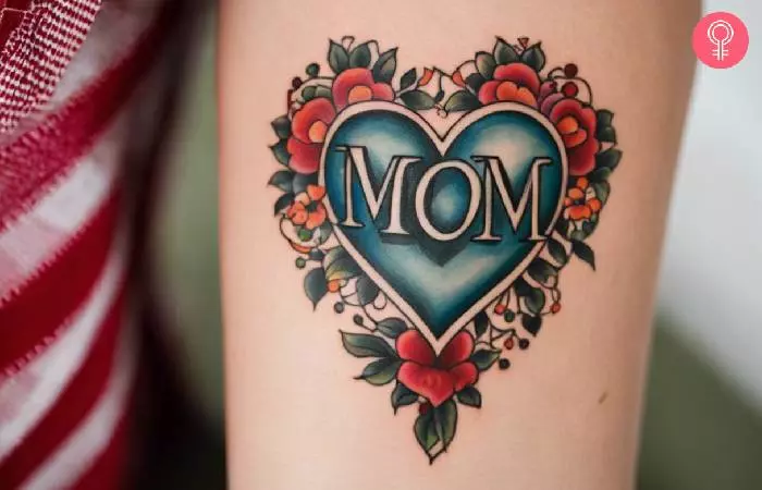A woman with a mom heart tattoo on the forearm