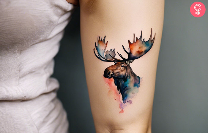 A woman with a moose head tattoo on her back