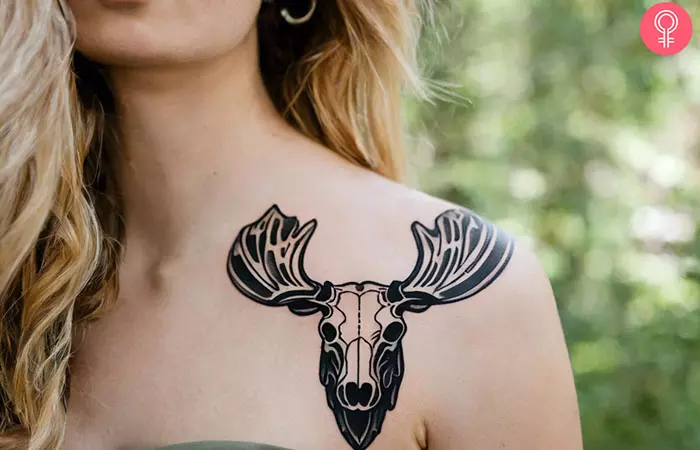 A woman with a moose skull tattoo on her upper arm