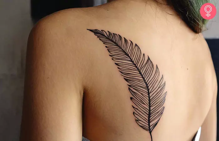 A woman with a palm leaf tattoo on her shoulder blade