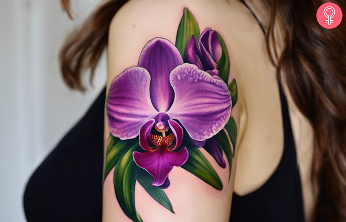 A woman with a purple orchid tattoo on her forearm