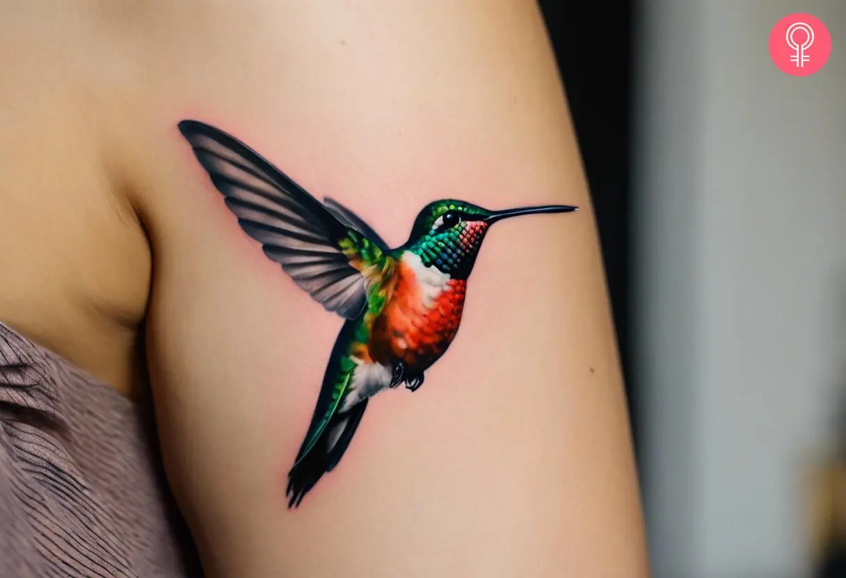 A woman with a realistic hummingbird tattoo on her shoulder