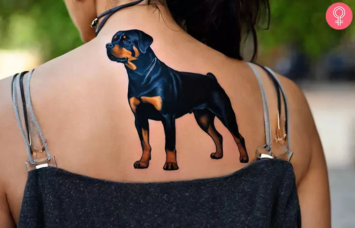 A woman with a realistic rottweiler tattoo
