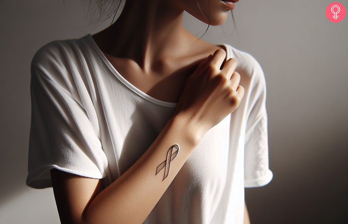 A woman with a ribbon tattoo on her forearm