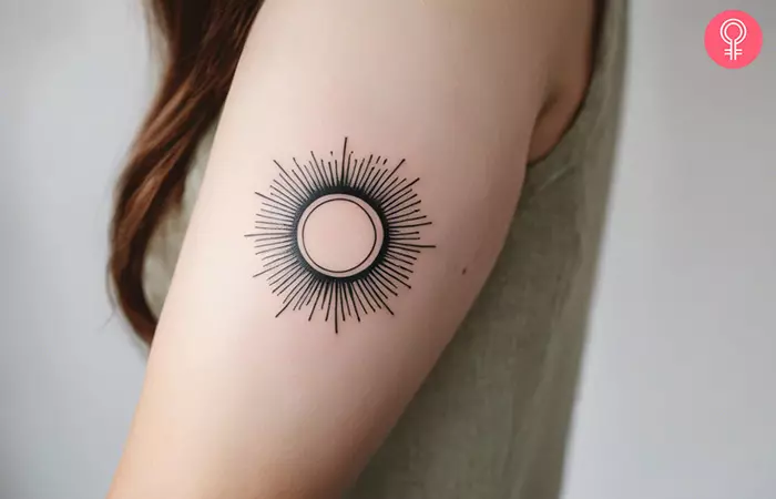 A woman with a rising sun tattoo on her arm