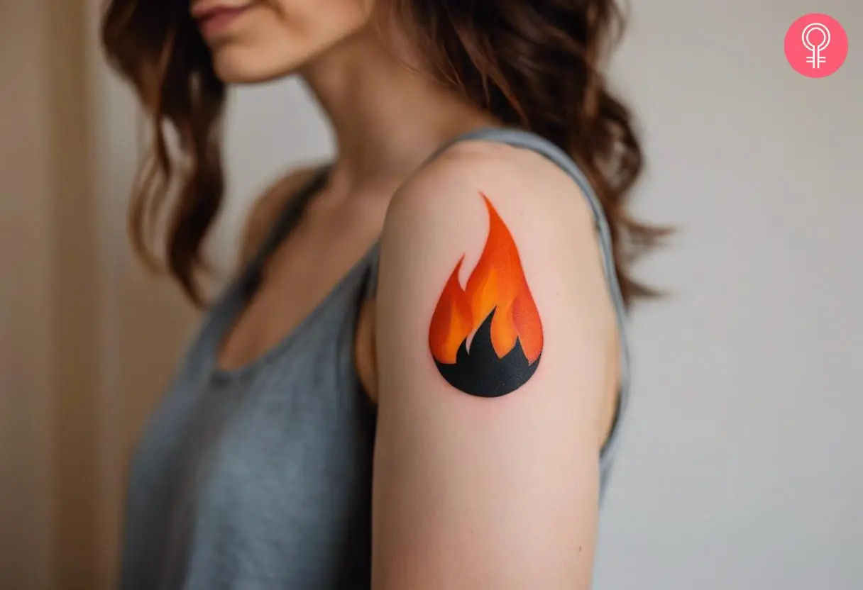 A woman with a simple flame tattoo on her upper arm