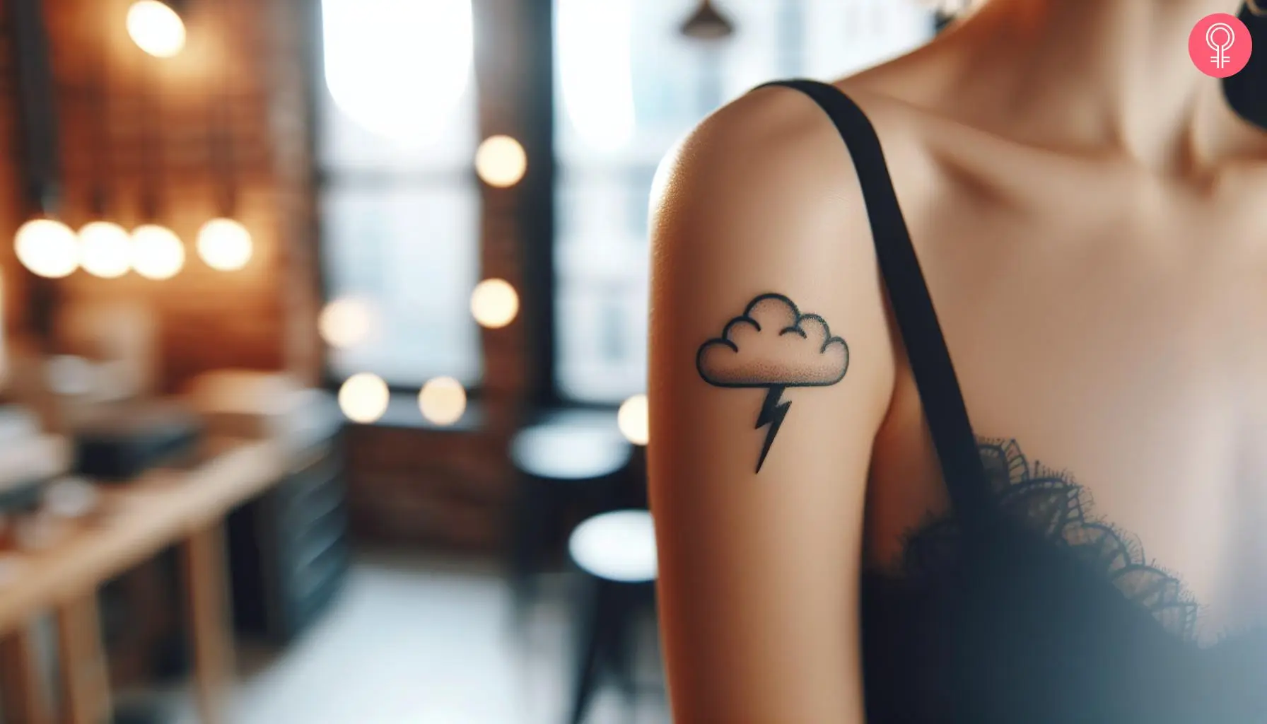 A woman with a small cloud with a lightning bolt tattoo on her upper arm