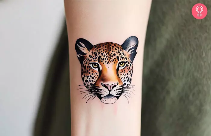 A woman with a small leopard print tattoo on her wrist