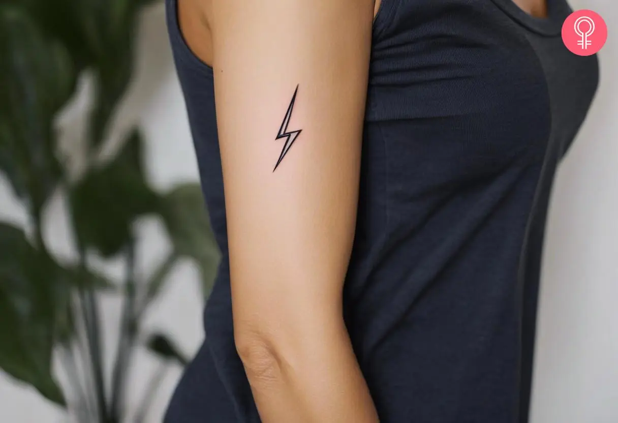 A woman with a small lightning bolt tattoo on her upper arm