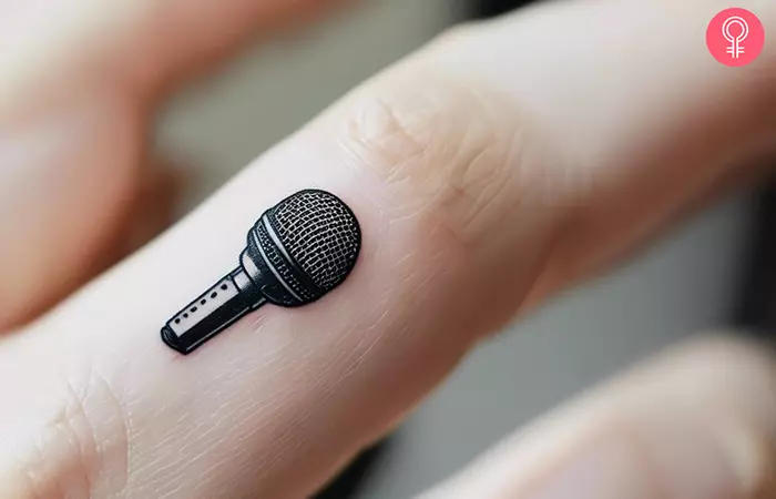 A woman with a small microphone tattoo on her finger