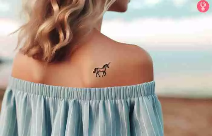 A woman with a small unicorn tattoo on her back