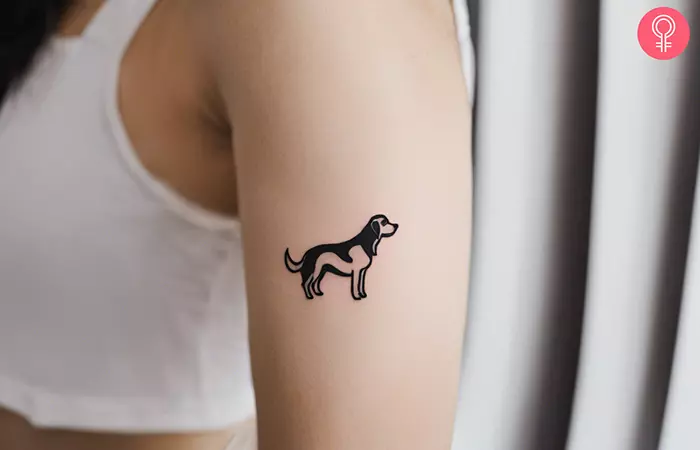A woman with a subtle dog tattoo on upper arm