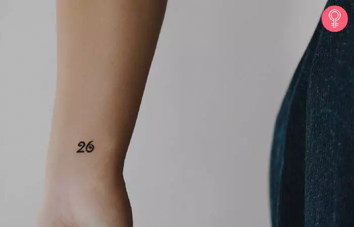 A woman with a tattoo for runners on her wrist