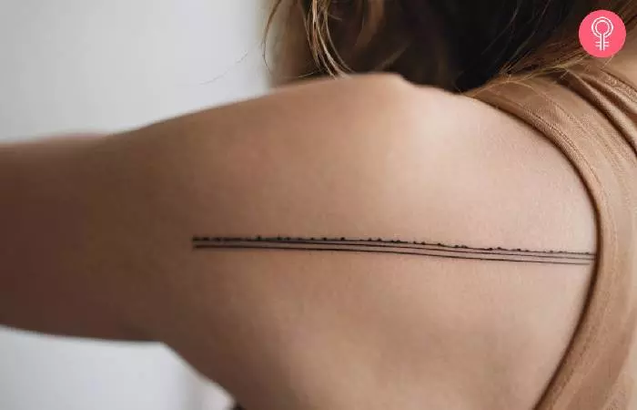 A woman with a tattoo of a running trail on her back