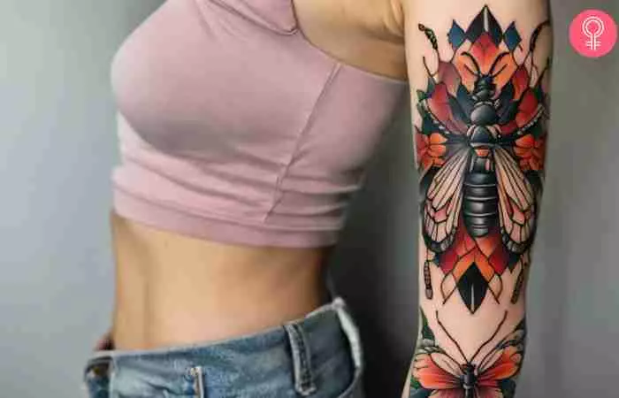 A woman with a tattoo of colorful insects on her arm