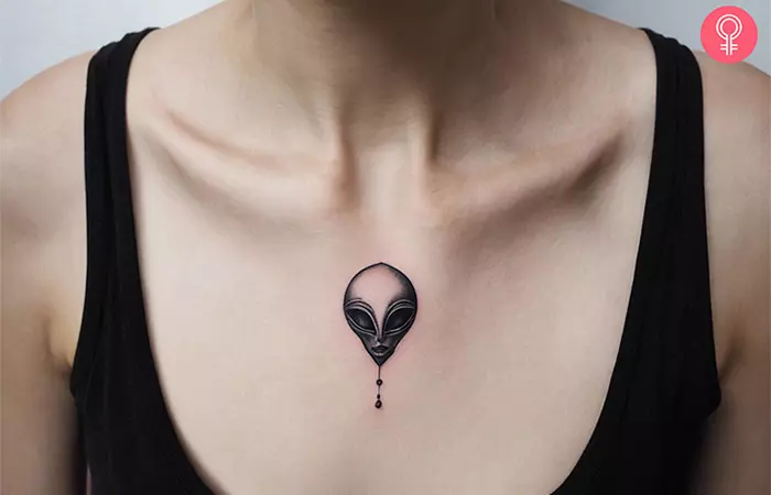 A woman with a tiny alien tattoo on her chest