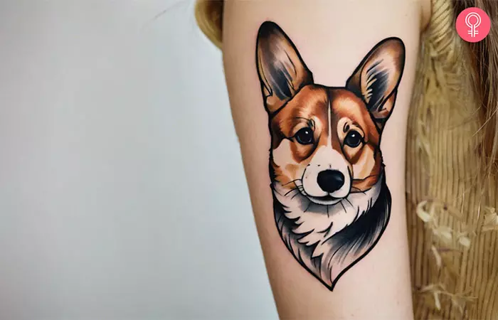 A woman with a traditional corgi tattoo design on her upper arm