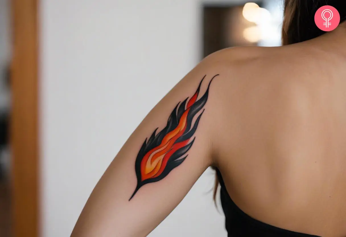 A woman with a traditional flame tattoo on her upper arm