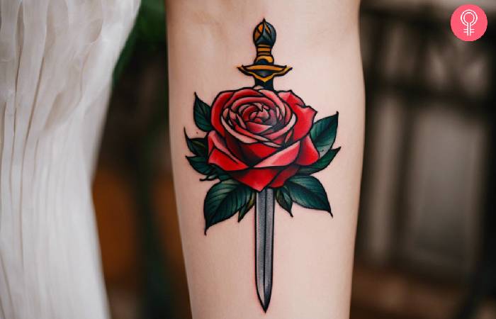A woman with a traditional rose and dagger tattoo