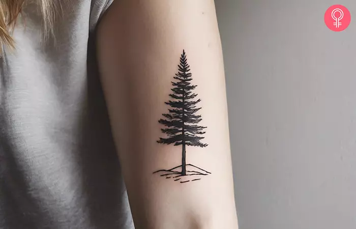 A woman with a tree tattoo on the inner arm
