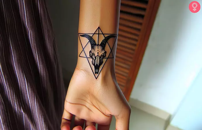 A woman with a triangle goat skull tattoo