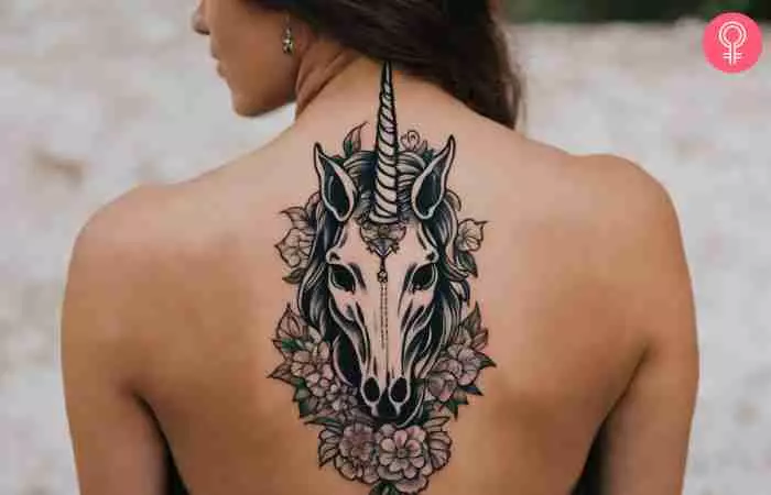 A woman with a unicorn skull tattoo