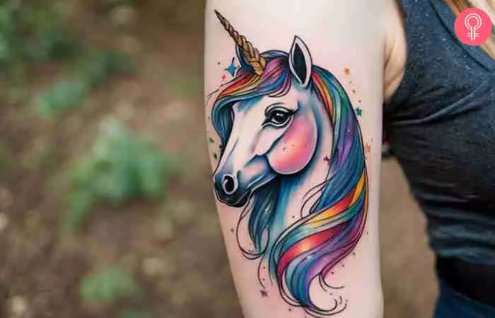 A woman with a unicorn tattoo on her upper arm