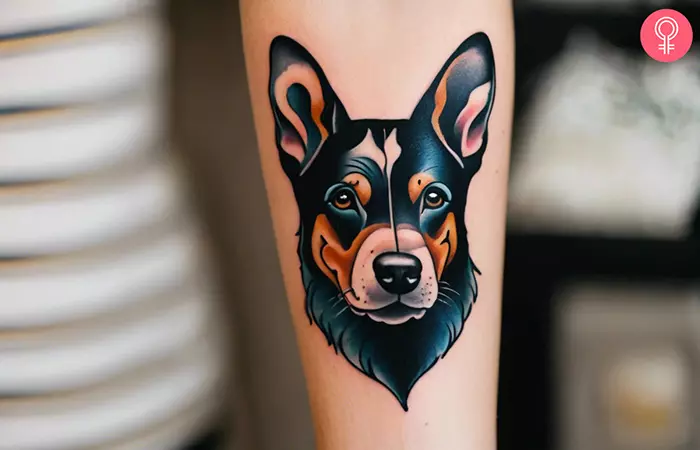 A woman with a vibrant dog portrait tattoo on forearm