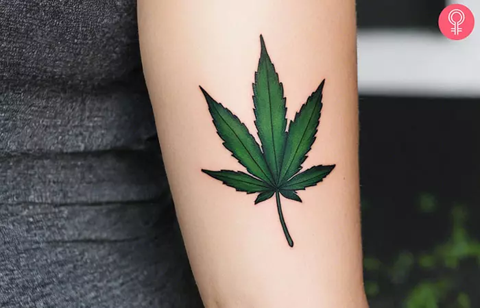 A woman with a weed leaf tattoo on her arm