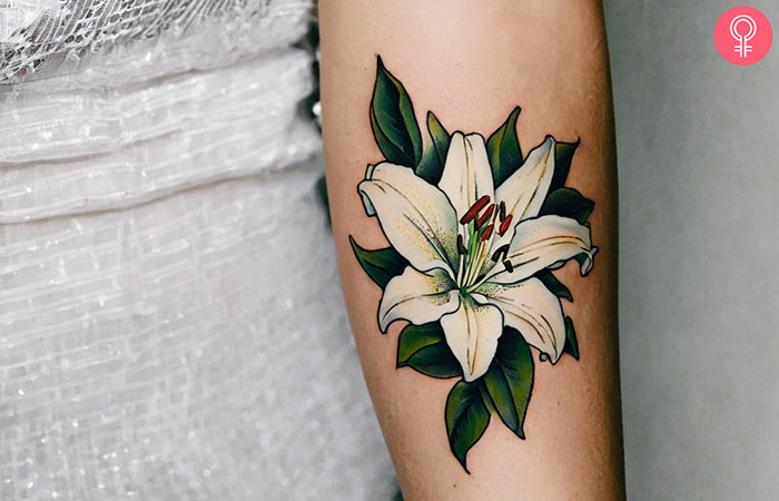 A woman with a white lily tattoo design on her arm